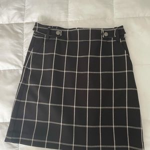 Above knee lined skirt with fashion tabs on sides.